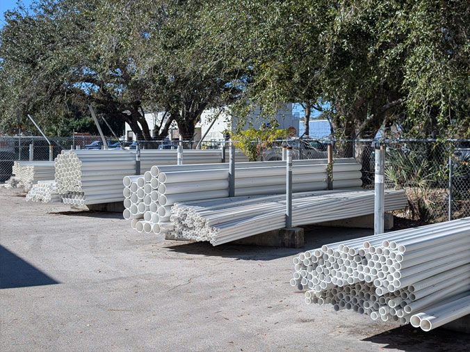 Stacks of PVC pipe in the Hughes Pplumbing Supply Naples Florida lot